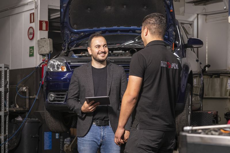 Adviseur van Prevensa op locatie in gesprek met een monteur in een autowerkplaats
